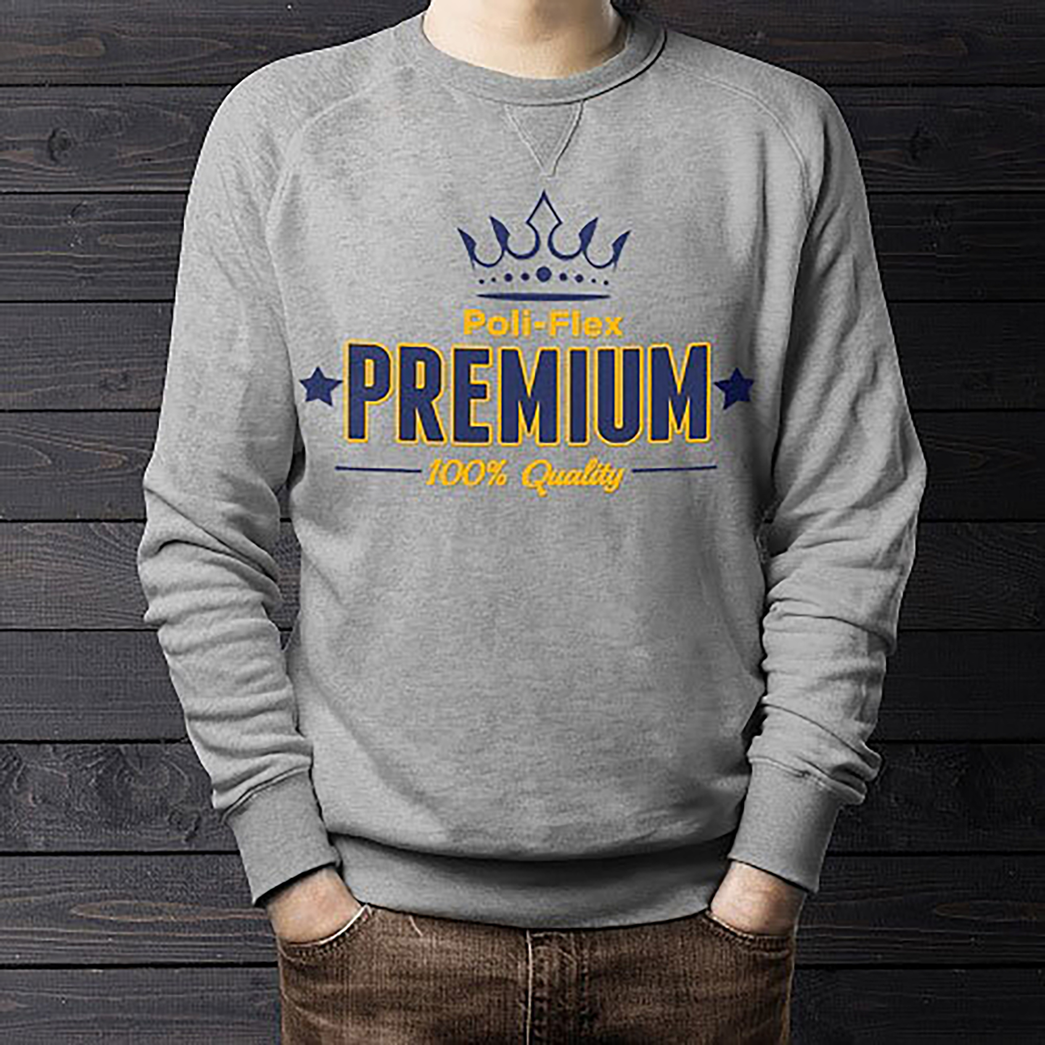 A person wearing a grey sweatshirt with a blue crown graphic and the text